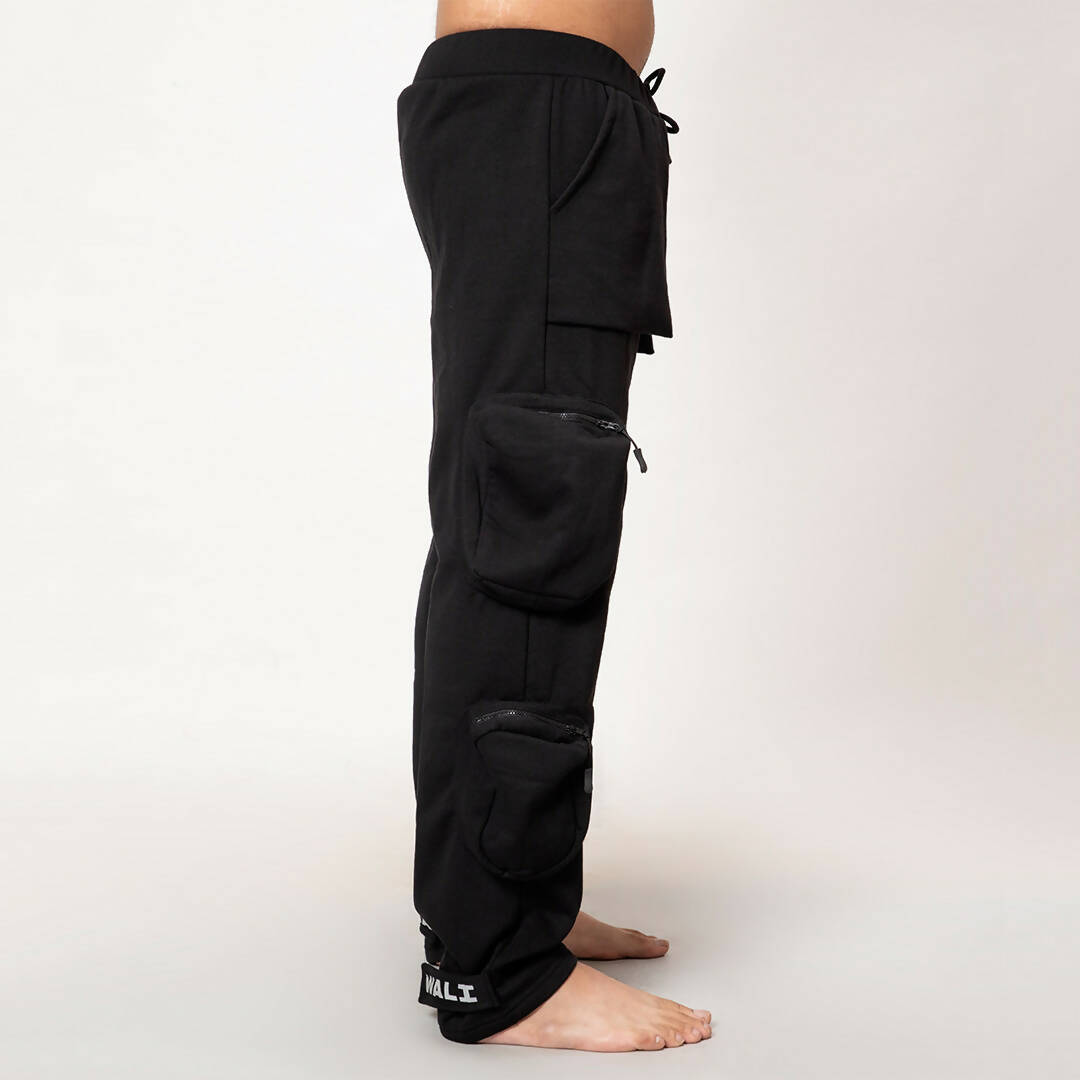 Side view of model wearing black heavyweight utility cargo pants by WalaWali