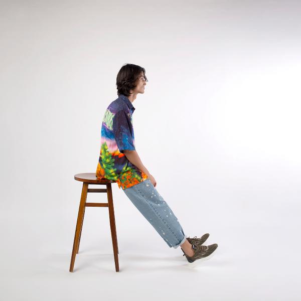 Model sitting on a chair wearing A Skating Monk Cats Fly On Christmas Shirt