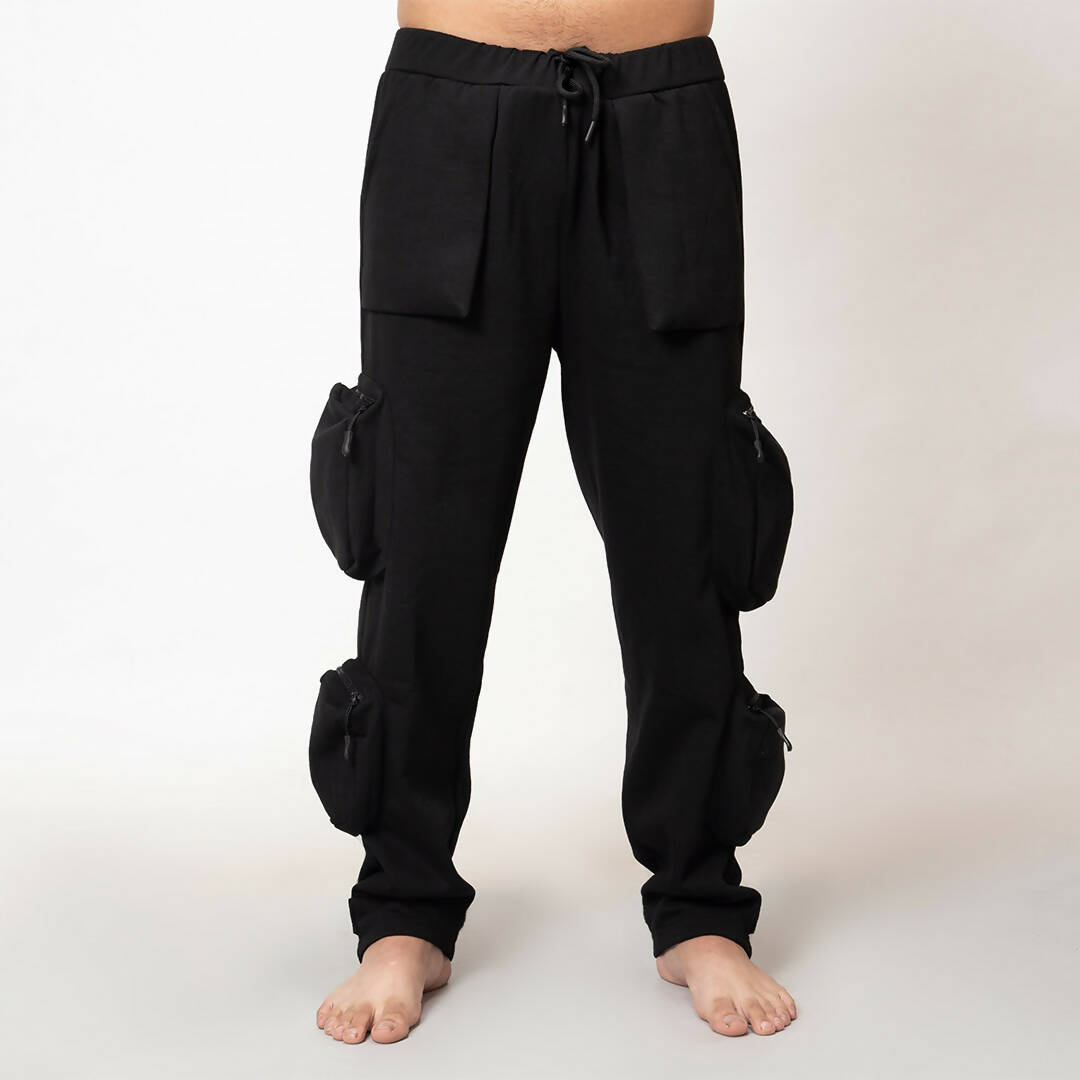 Front view of model wearing black heavyweight utility cargo pants by WalaWali, model is barefeet