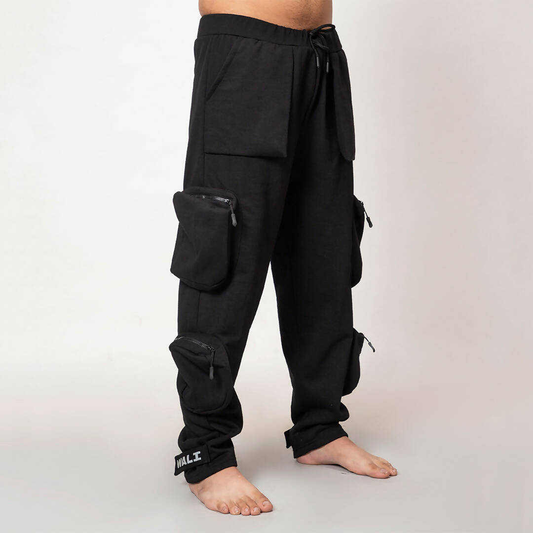 Angled view of model wearing black heavyweight utility cargo pants by WalaWali