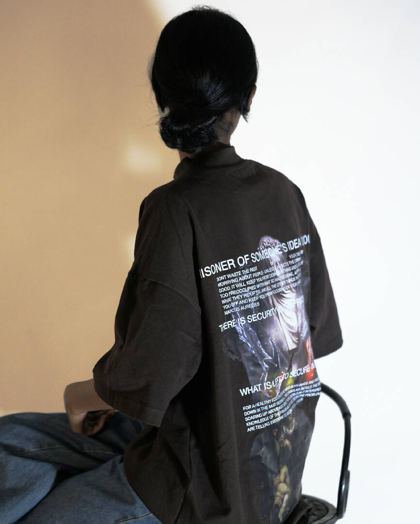 Female model wearing 'Prisoner of Mind' graphic T-Shirt, viewed from the back