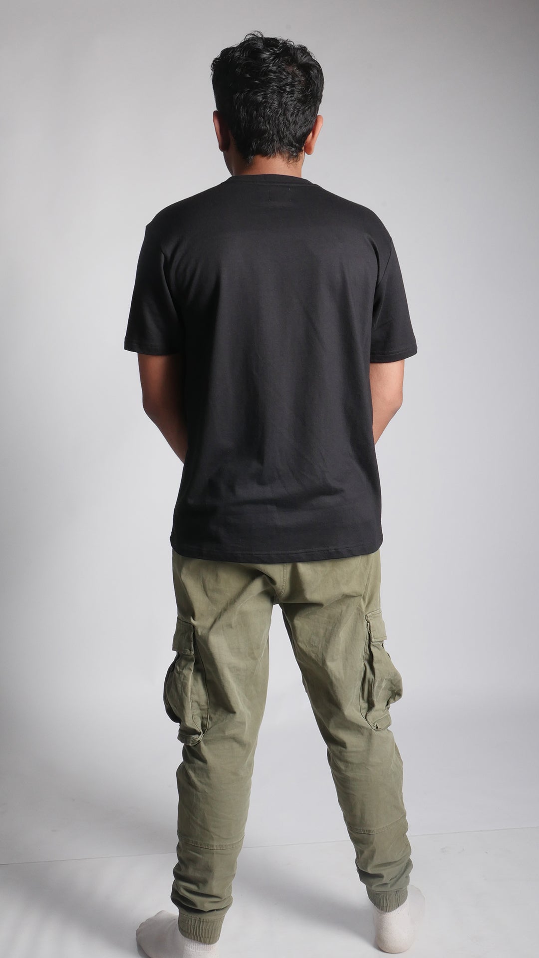 Back View of model wearing 10 Hills Studio Unisex 'Stop War' Black Boxy T-shirt