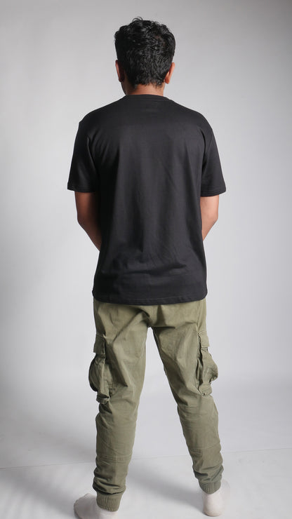 Back View of model wearing 10 Hills Studio Unisex 'Stop War' Black Boxy T-shirt